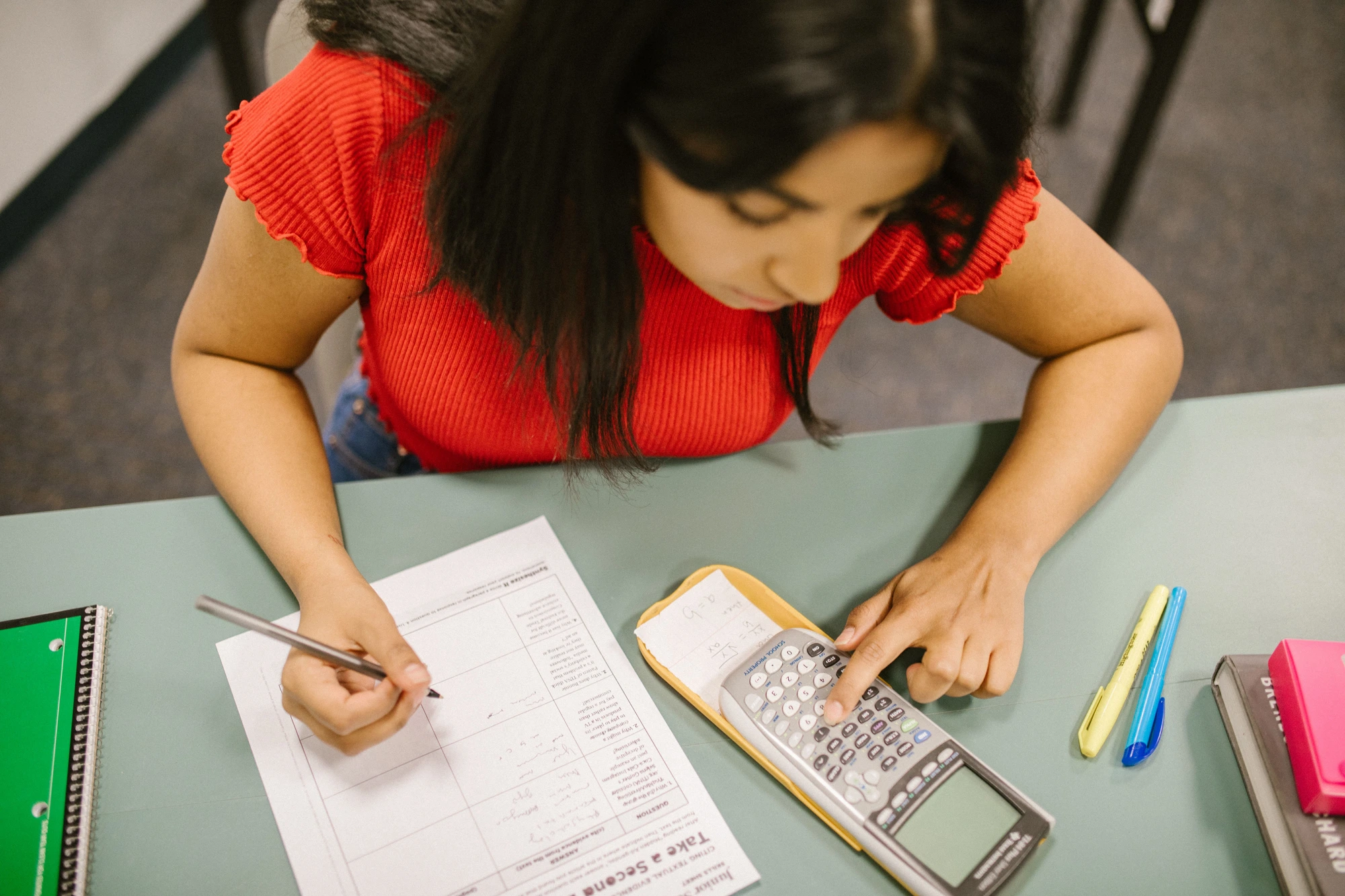 Student working through test-prep problems with a graphing calculator